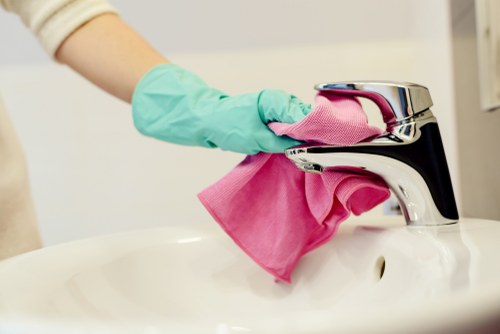 Professional carpet cleaner in Clapham deep cleaning a living room carpet